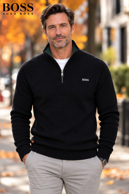 Man wearing a black ribbed-knit half-zip sweater with chinos – front view