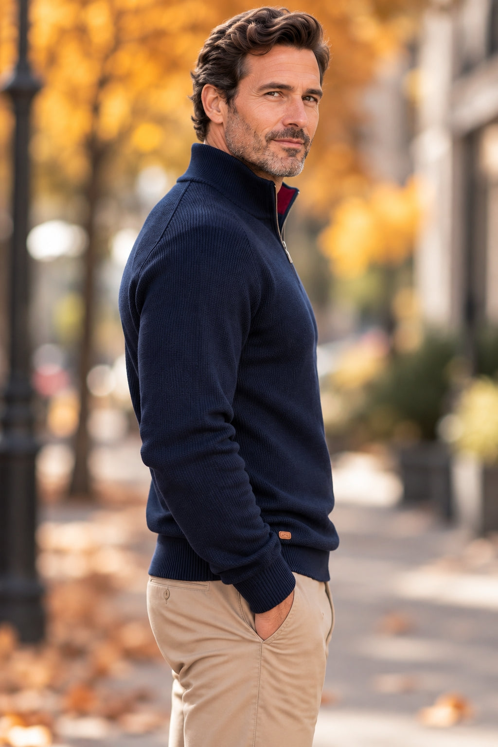 Side view of a man in a navy half-zip knit sweater